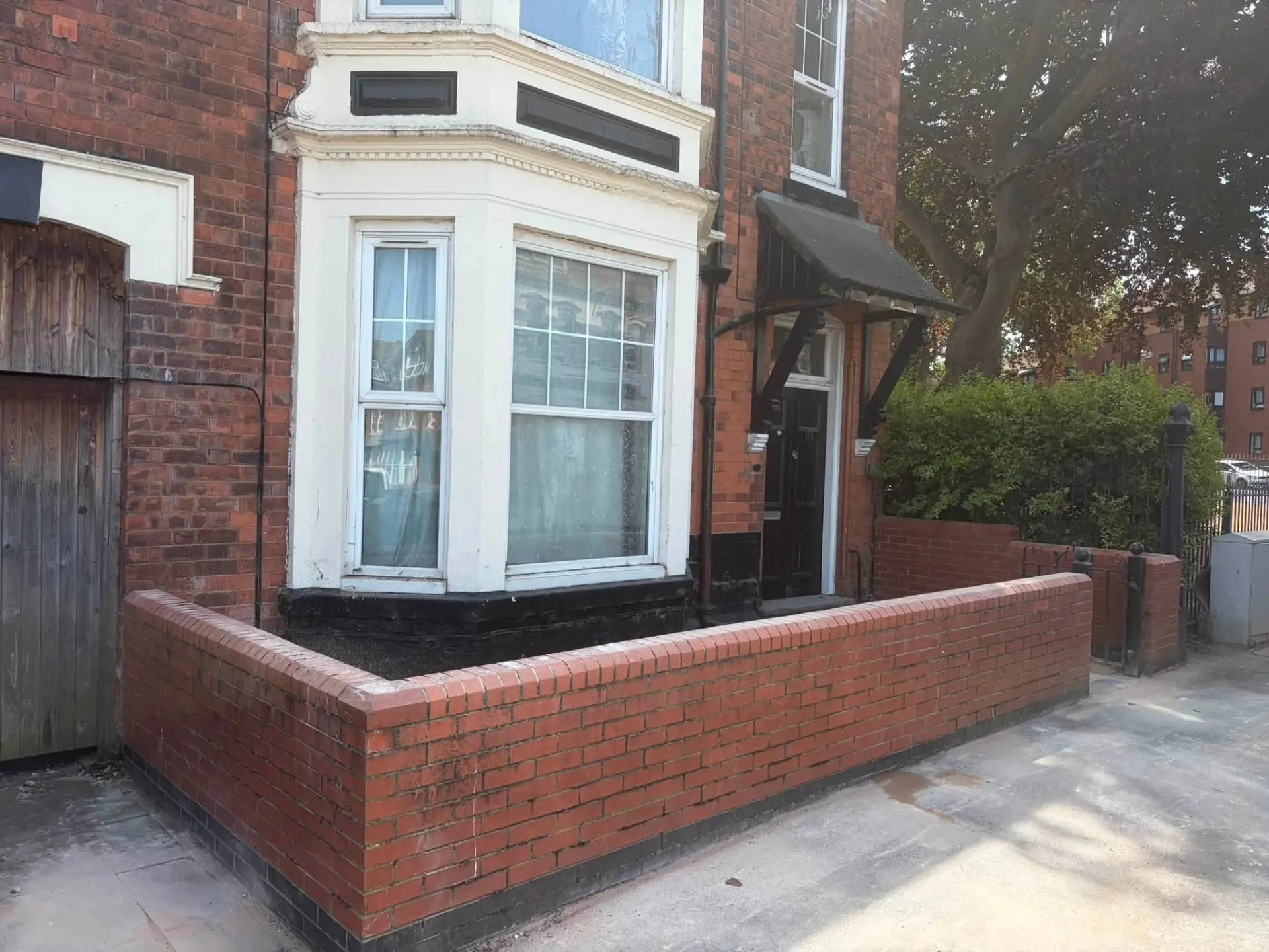 The same front garden wall completely cleared of all waste
