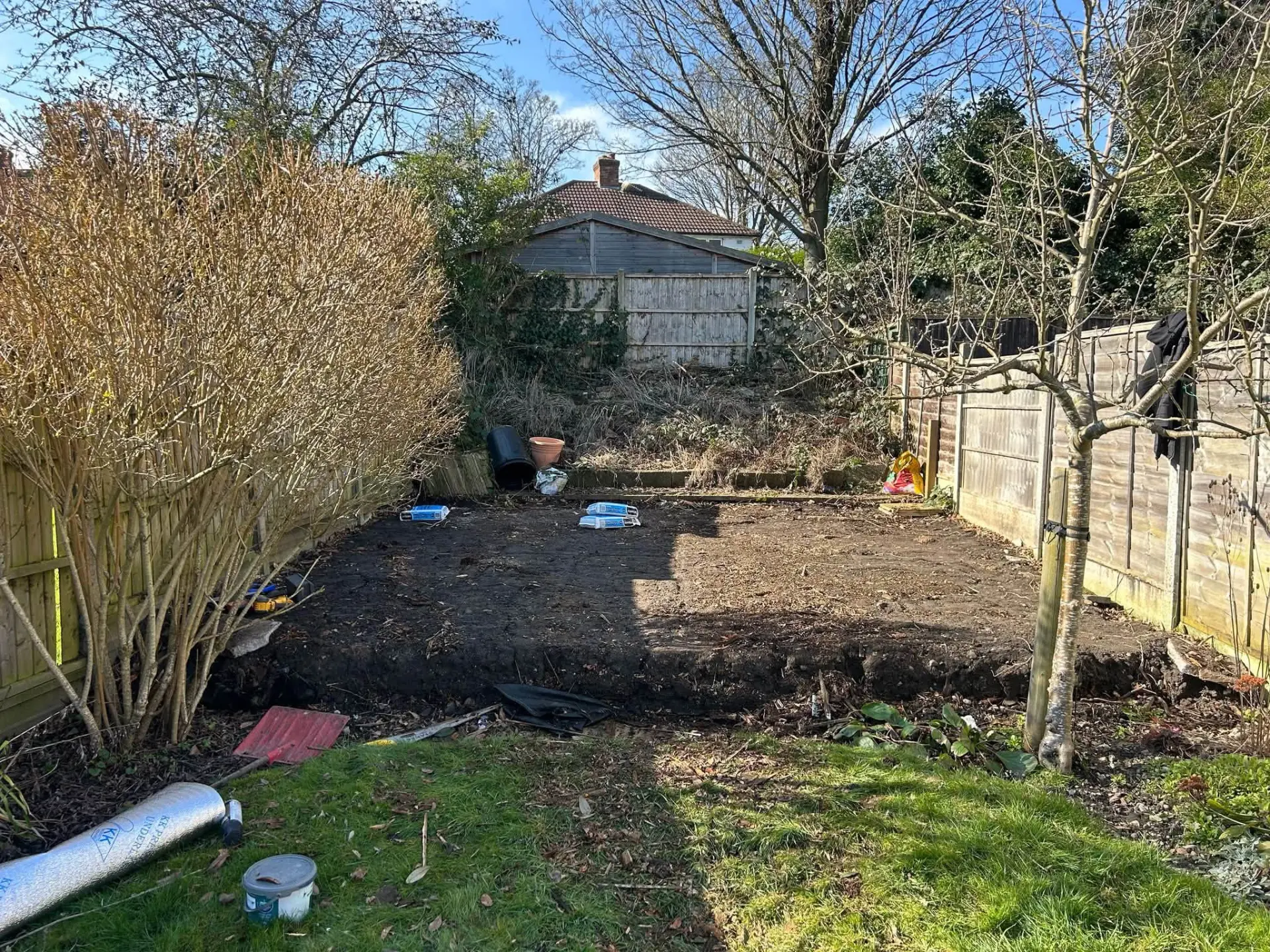 Garden stripped back to bare soil before the new patio and landscaping work